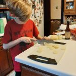 A Scout prepares his camp-style meal.